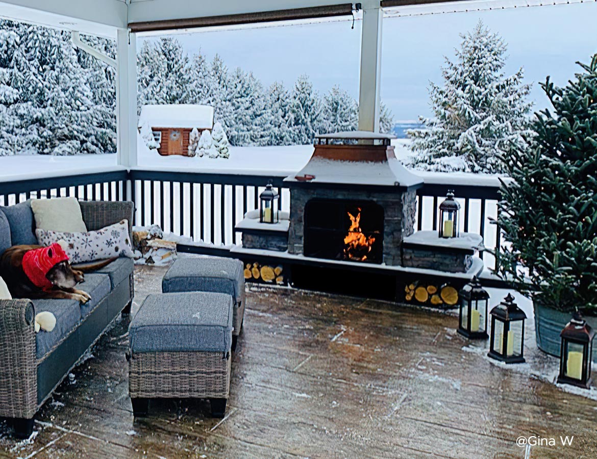Gazebo with firepit and seating area in a snowy backyard for year-round comfort